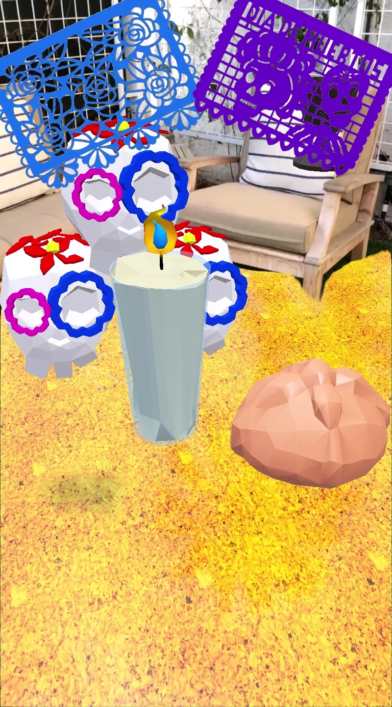 Filtro de Snapchat que coloca una ofrenda virtual con calaveritas, veladora, pan de muerto, papel picado y cempasúchil